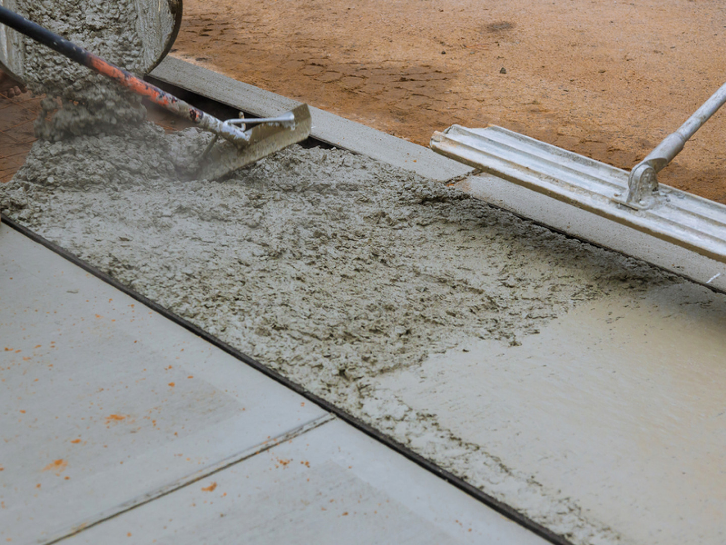 image of  concrete workers laying concrete